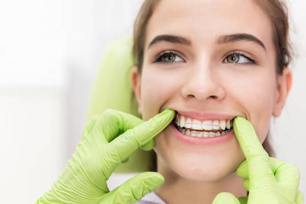 Young woman smiling showing white teeth